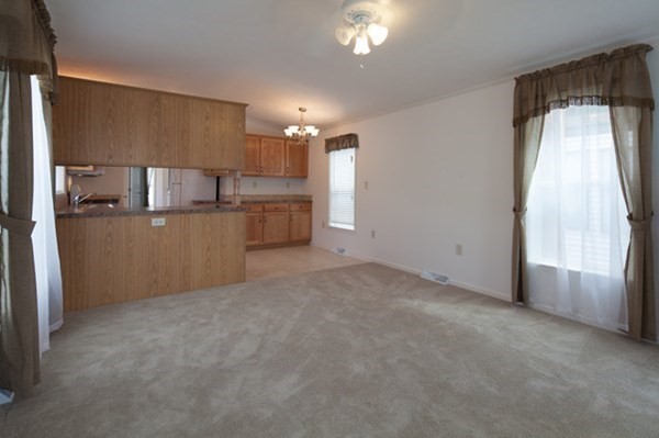 1044 Phillips Road, Unit 12 New Bedford, MA 02745 - Photo 2 of 9 a view of a kitchen with a sink refrigerator and window