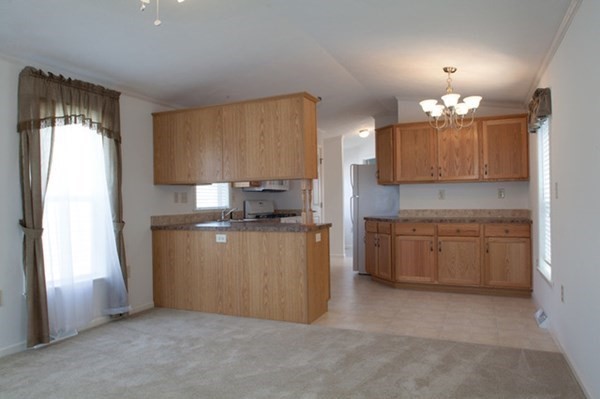 1044 Phillips Road, Unit 12 New Bedford, MA 02745 - Photo 3 of 9 a kitchen with a refrigerator and microwave