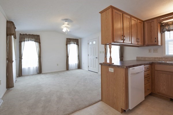 1044 Phillips Road, Unit 12 New Bedford, MA 02745 - Photo 4 of 9 a view of a kitchen with granite countertop cabinets and a refrigerator
