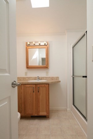 1044 Phillips Road, Unit 12 New Bedford, MA 02745 - Photo 8 of 9 a bathroom with a sink a mirror and a bathtub