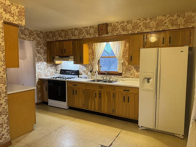 a kitchen with stainless steel appliances a refrigerator and a stove