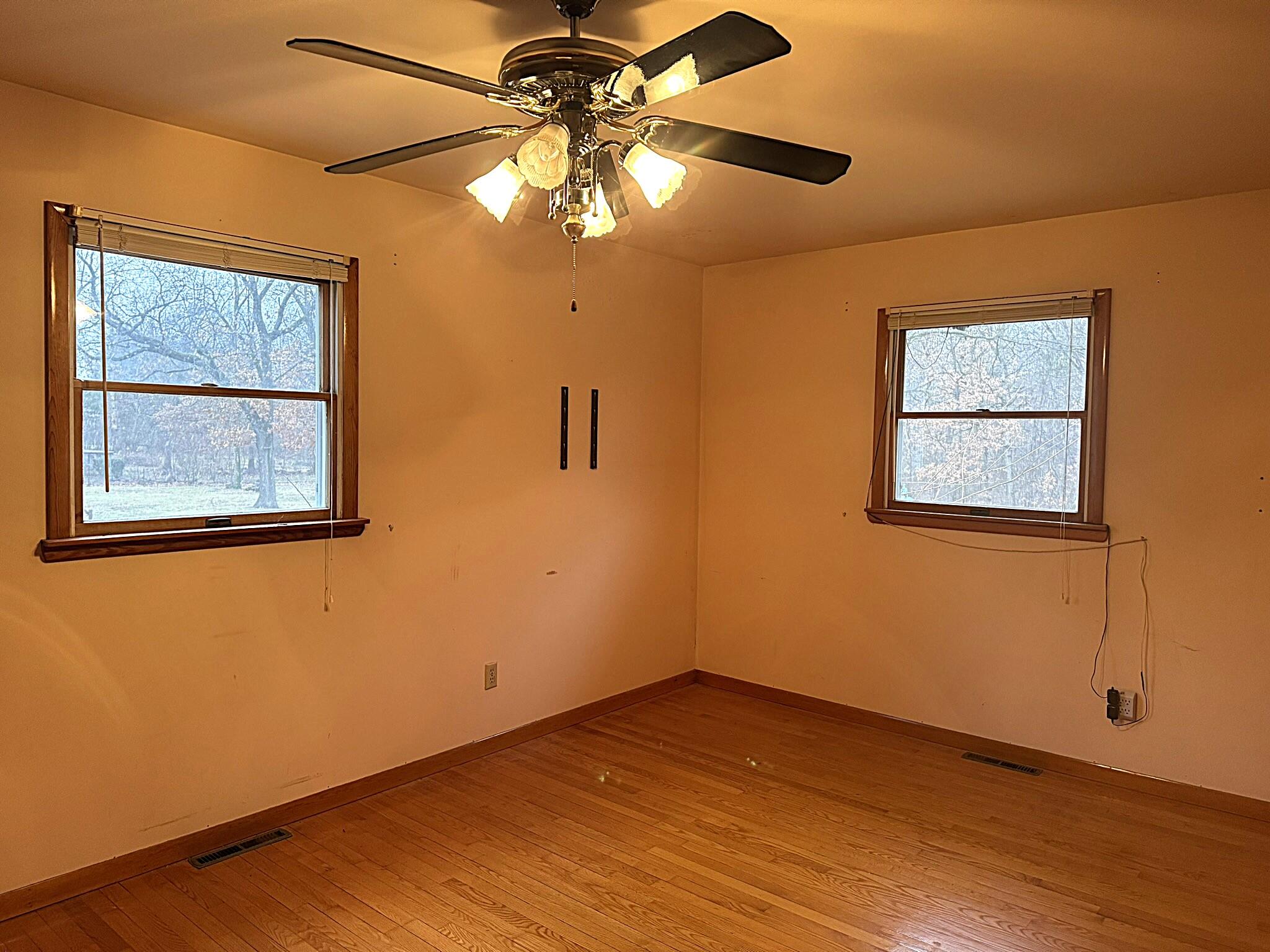 11108 North 550 East Demotte, IN 46310 - Photo 24 of 42 a view of an empty room with wooden floor and a window