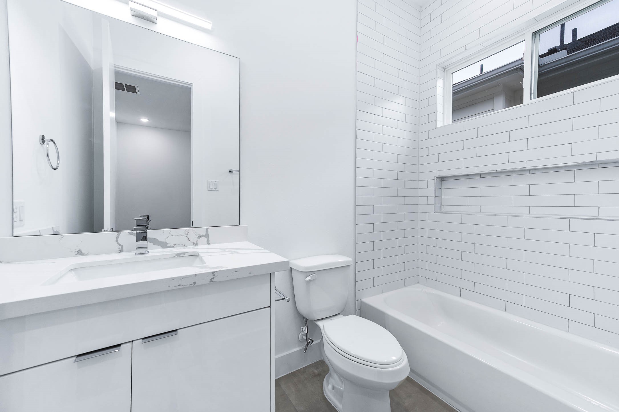 3509 McIlhenny Street Houston, TX 77004 - Photo 29 of 36 a bathroom with a granite countertop sink toilet mirror and bathtub