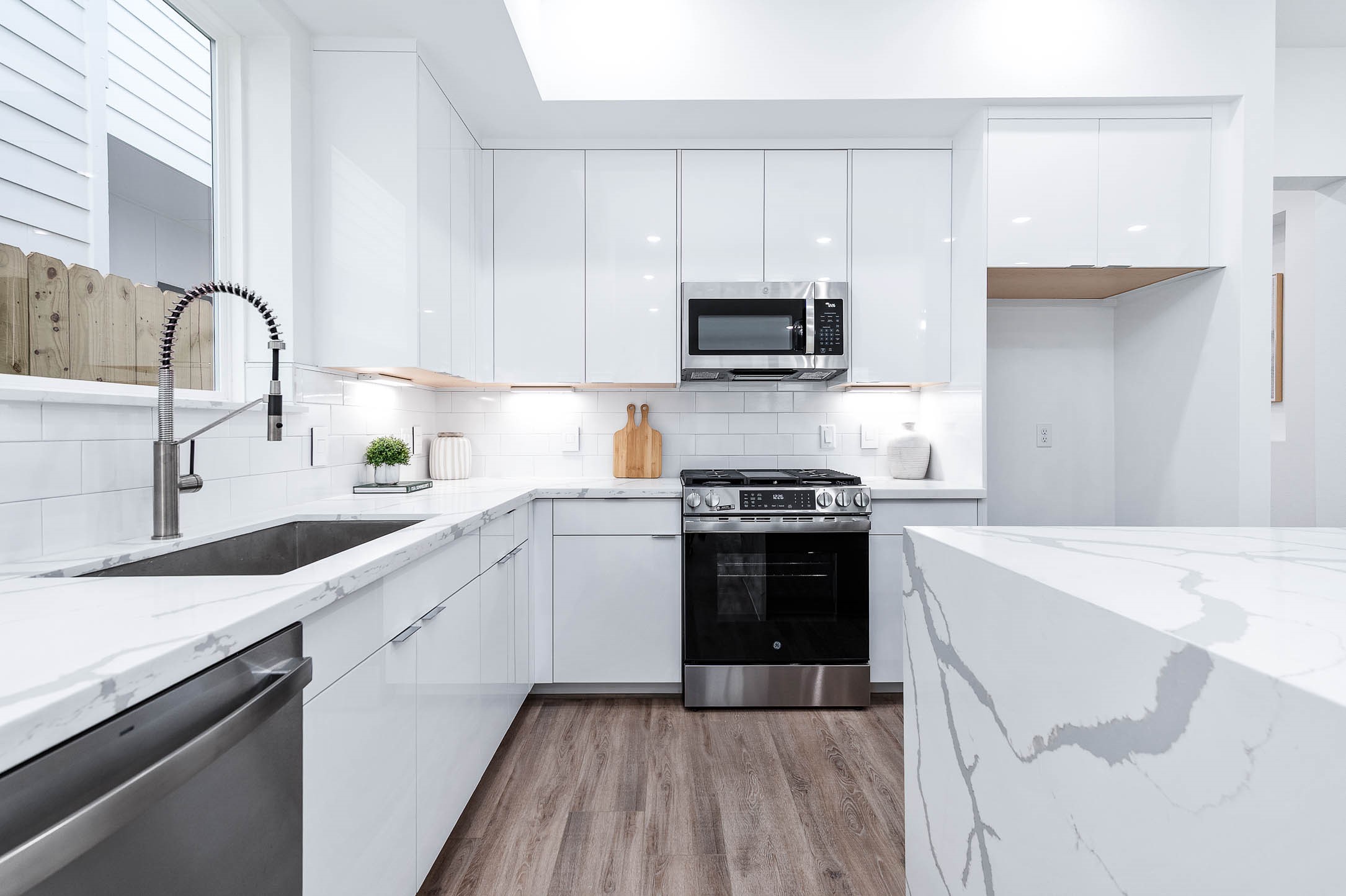 3509 McIlhenny Street Houston, TX 77004 - Photo 10 of 36 a kitchen with a sink stove and white cabinets