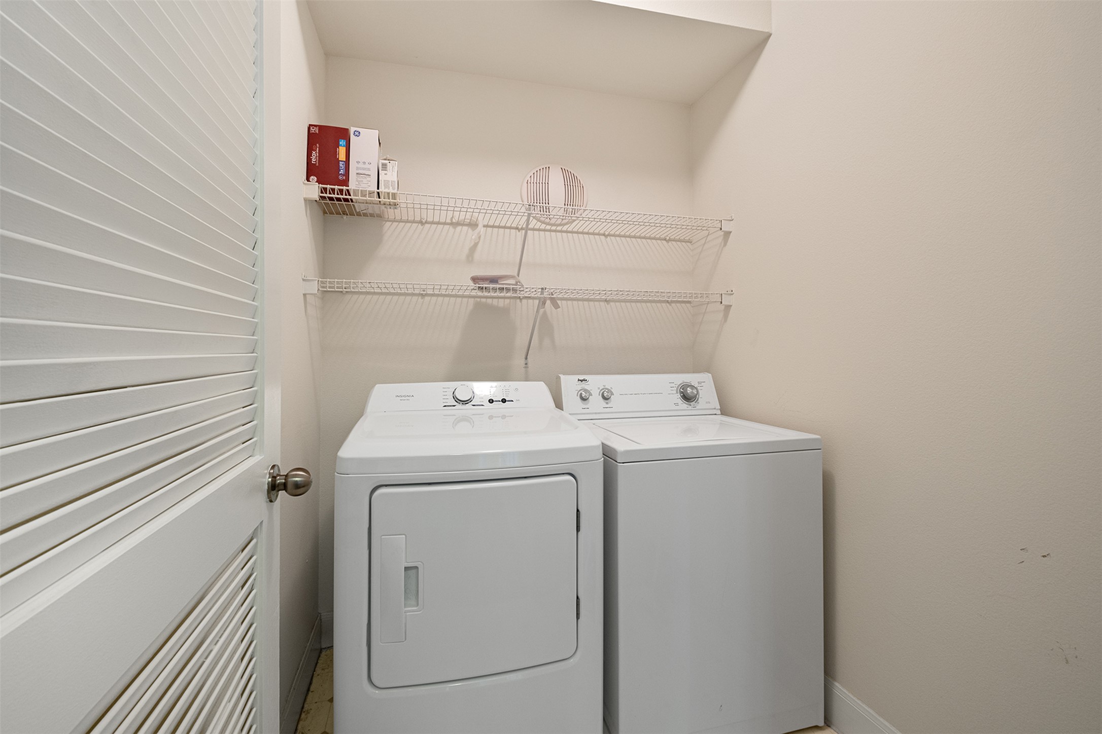 7701 Rialto Boulevard, Unit 637 Austin, TX 78735 - Photo 4 of 25 A dedicated utility space with wire shelving, offering practical laundry solutions.