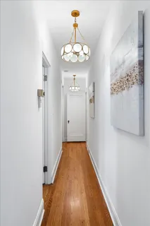 a bedroom with a large bed and a lamp on table