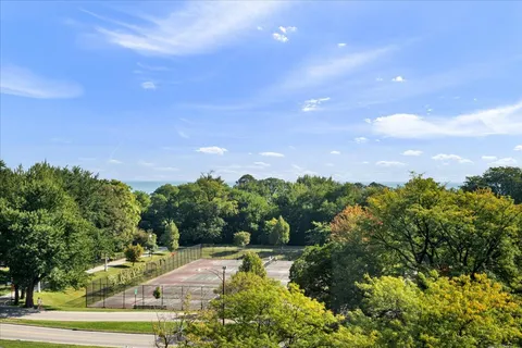 a view of a livingroom with furniture wooden floor and a chandelier