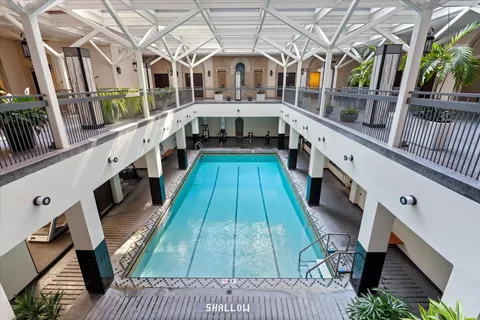 a living room with furniture a fireplace and a chandelier