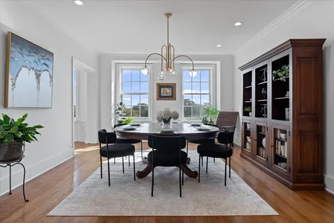 a living room with fireplace furniture and wooden floor