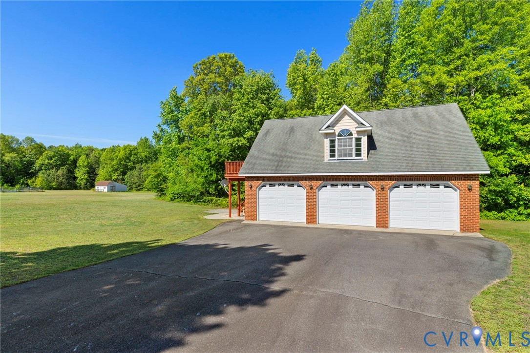 15441 Goshen Road Montpelier, VA 23192 - Photo 35 of 47 a front view of a house with a yard and garage