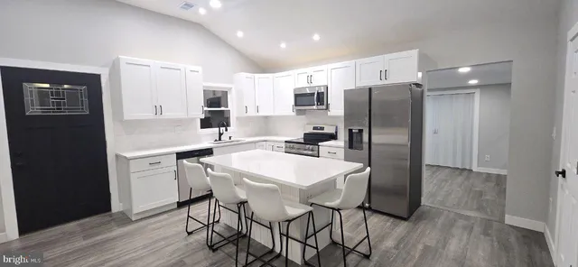 a kitchen with a refrigerator a sink and cabinets