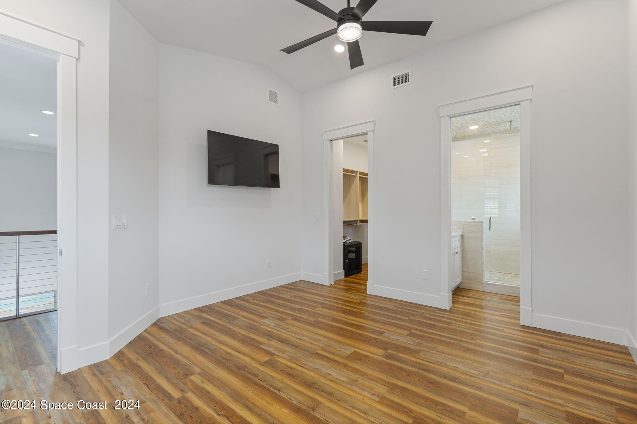 1760 Highway 1 Malabar, FL 32950 - Photo 14 of 40 a view of an empty room with wooden floor and a ceiling fan