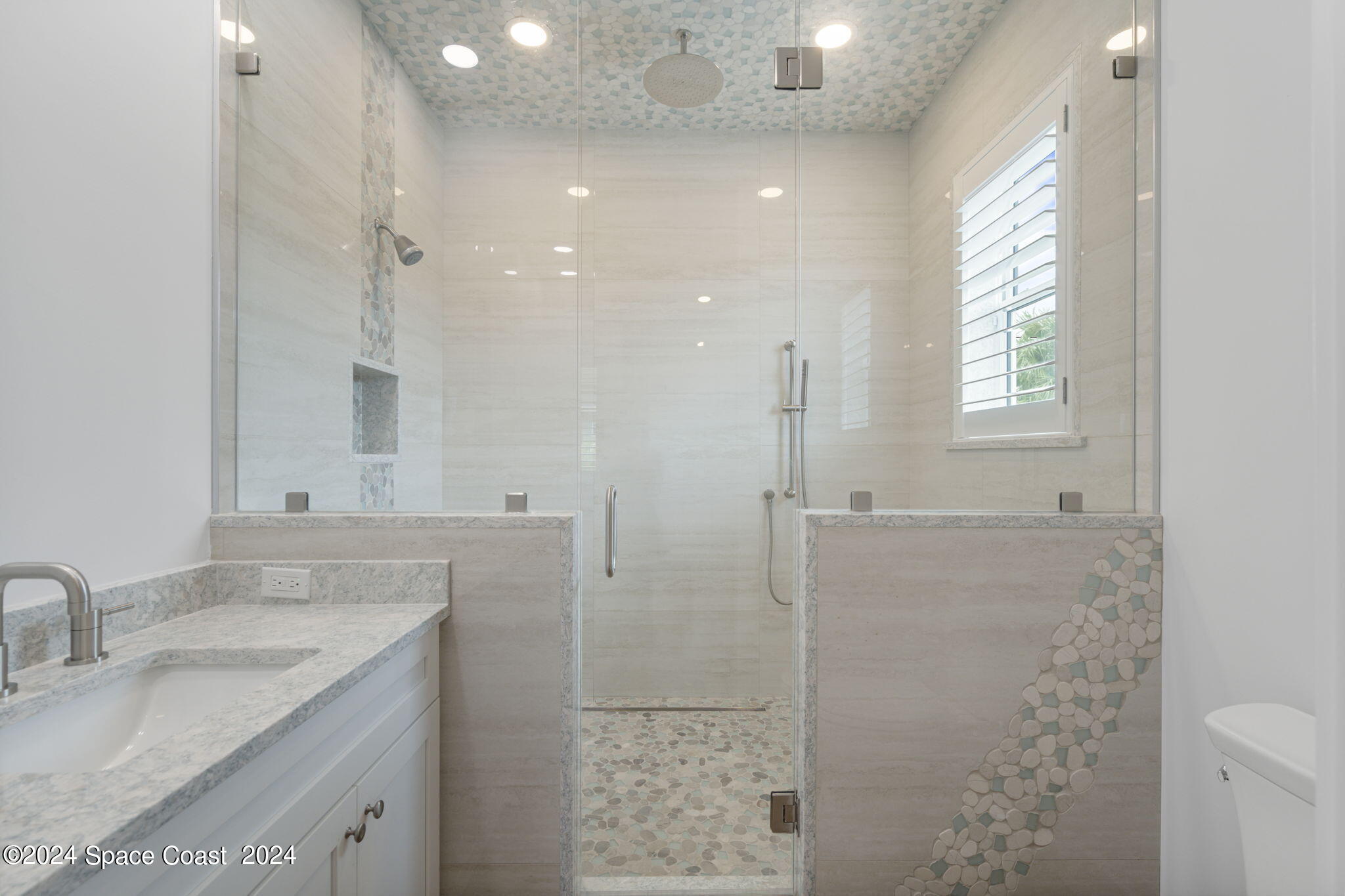 1760 Highway 1 Malabar, FL 32950 - Photo 15 of 40 a bathroom with a granite countertop sink a shower and a mirror