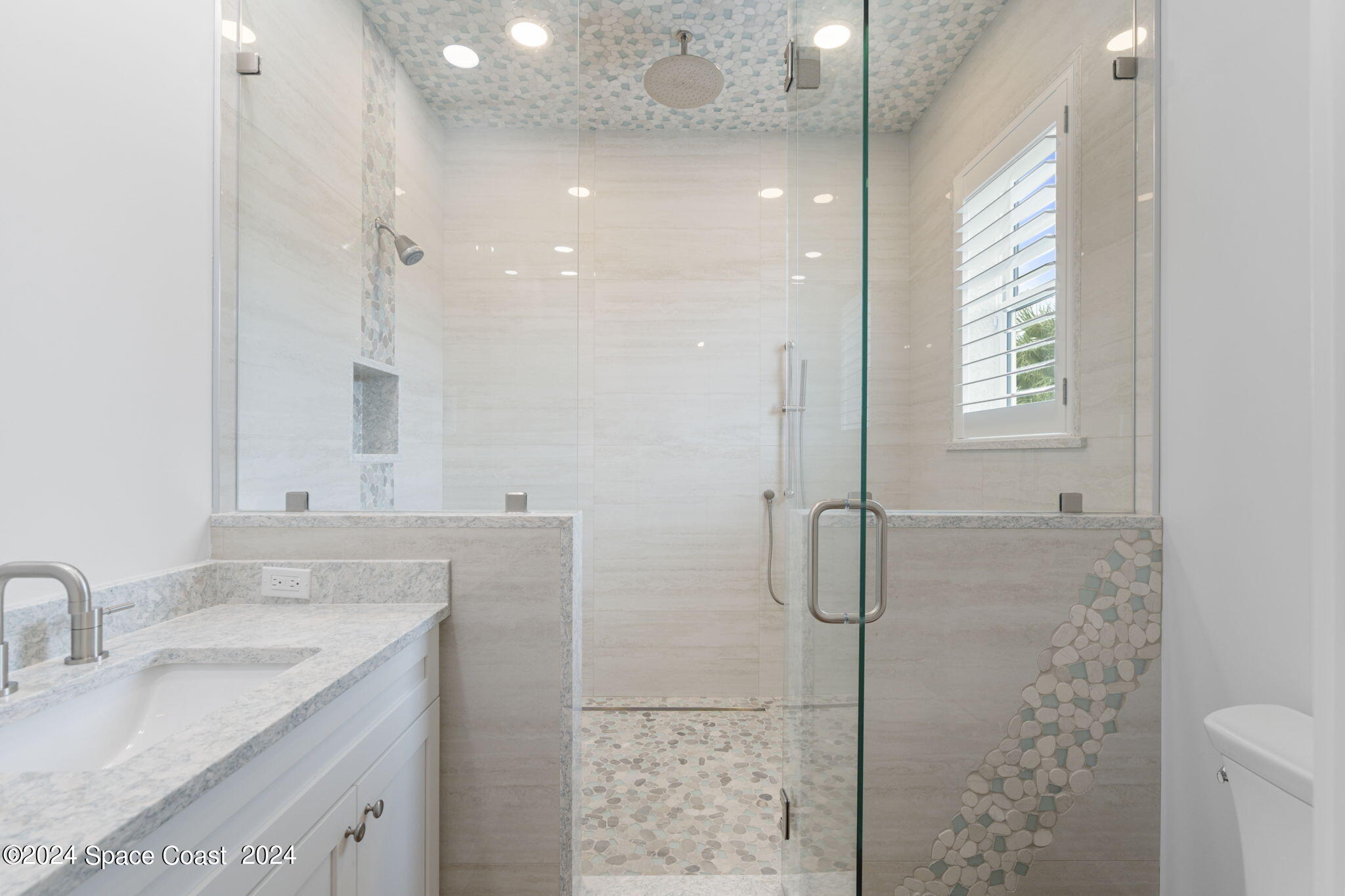1760 Highway 1 Malabar, FL 32950 - Photo 16 of 40 a bathroom with a granite countertop sink a shower and a mirror