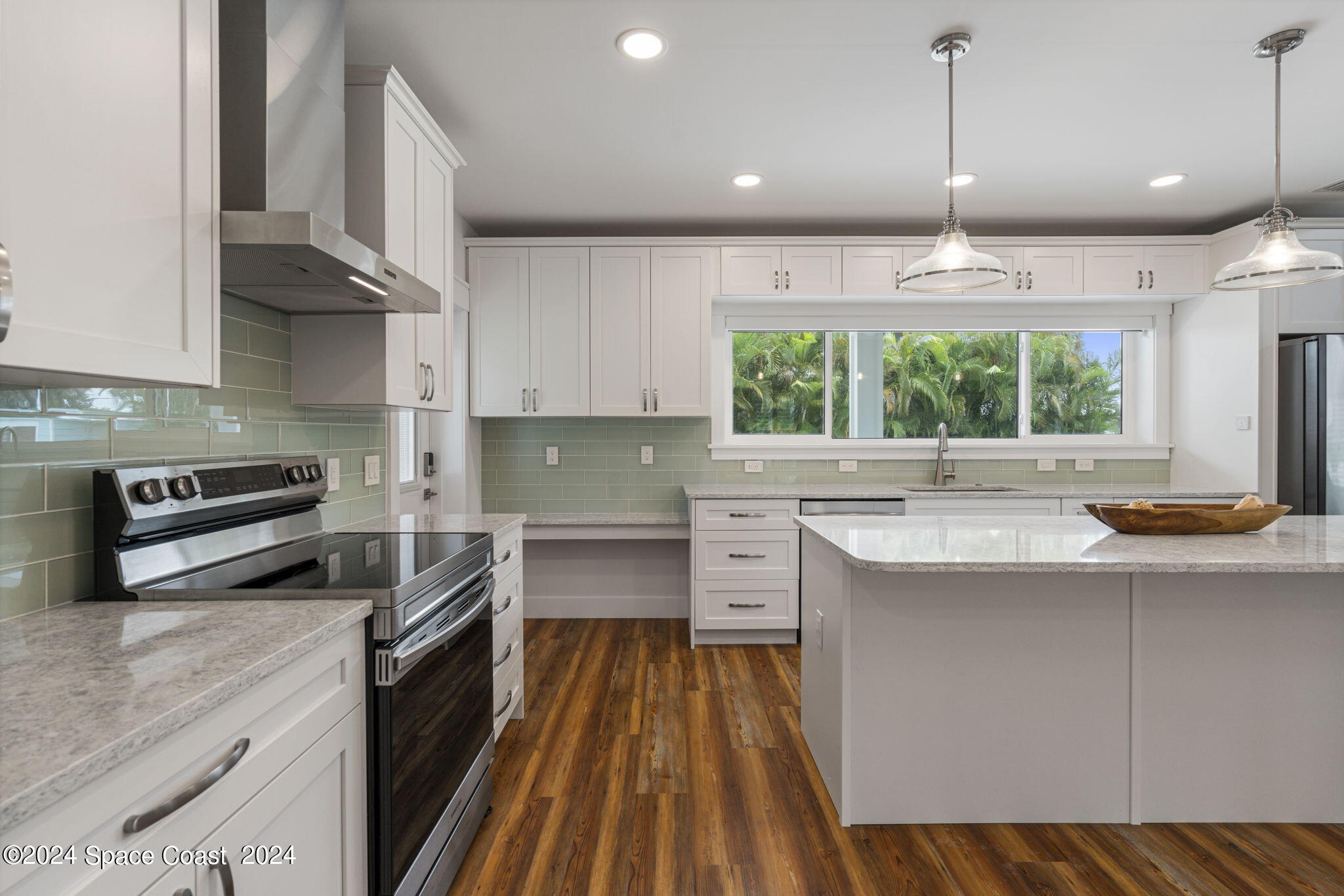 1760 Highway 1 Malabar, FL 32950 - Photo 24 of 40 a kitchen with stainless steel appliances a stove sink and cabinets