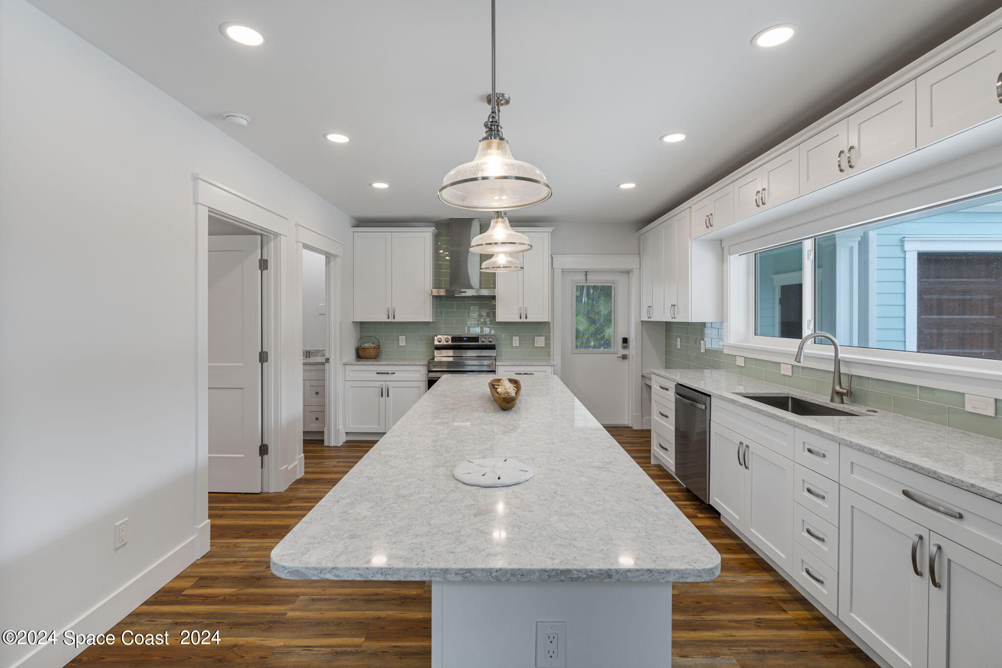 1760 Highway 1 Malabar, FL 32950 - Photo 25 of 40 a large kitchen with kitchen island a stove a sink a refrigerator and cabinets