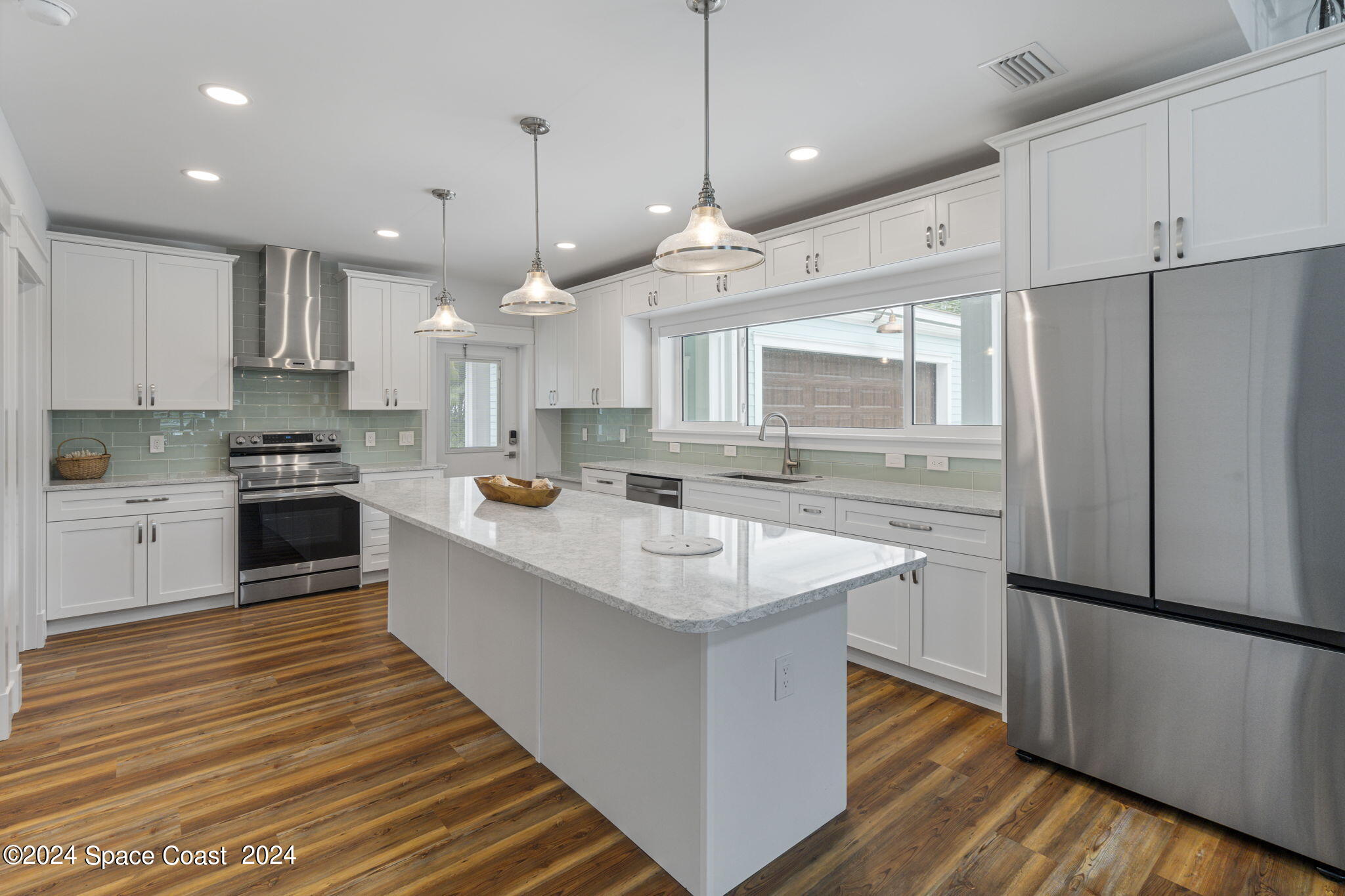 1760 Highway 1 Malabar, FL 32950 - Photo 26 of 40 a kitchen with kitchen island a sink stainless steel appliances and cabinets