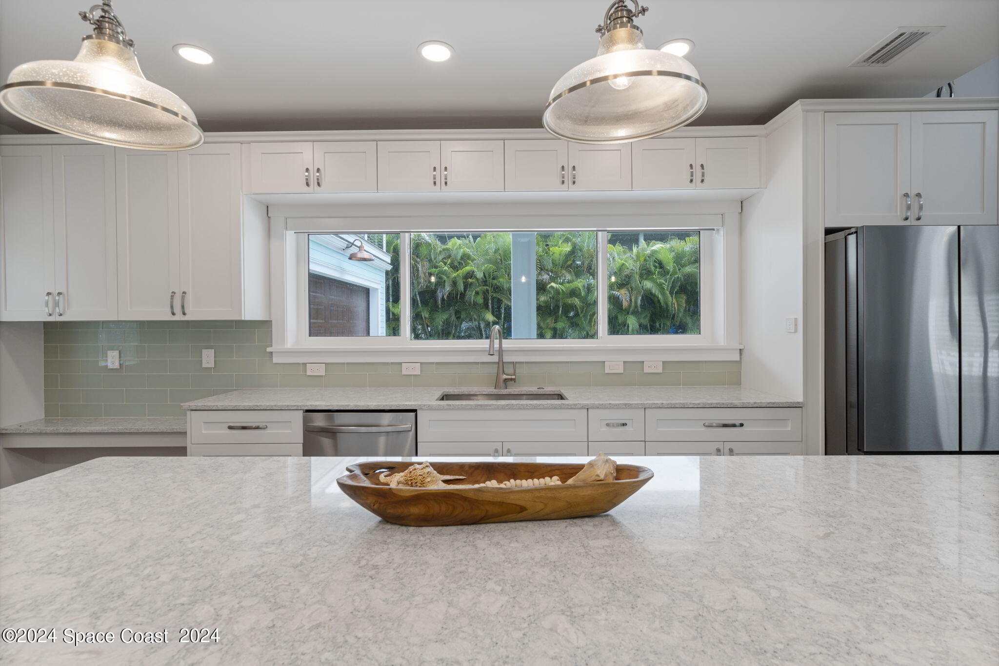 1760 Highway 1 Malabar, FL 32950 - Photo 27 of 40 a kitchen with stainless steel appliances a large counter top a stove and a refrigerator