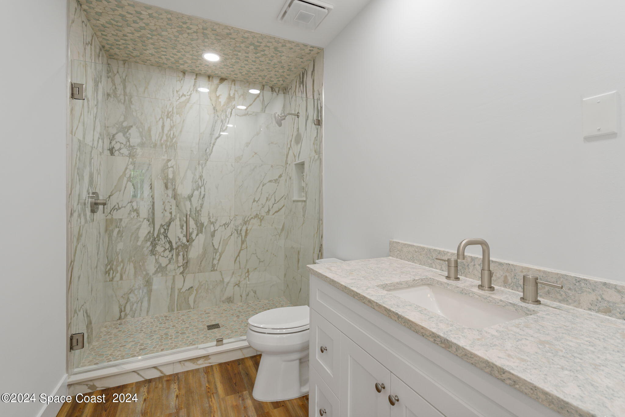 1760 Highway 1 Malabar, FL 32950 - Photo 28 of 40 a bathroom with a granite countertop sink a toilet and shower