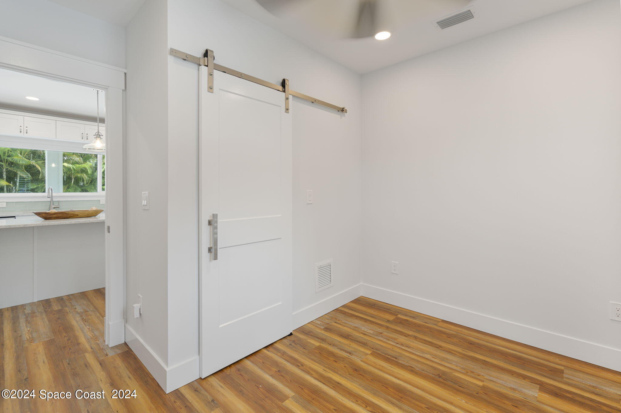 1760 Highway 1 Malabar, FL 32950 - Photo 29 of 40 a view of empty room with wooden floor and fan