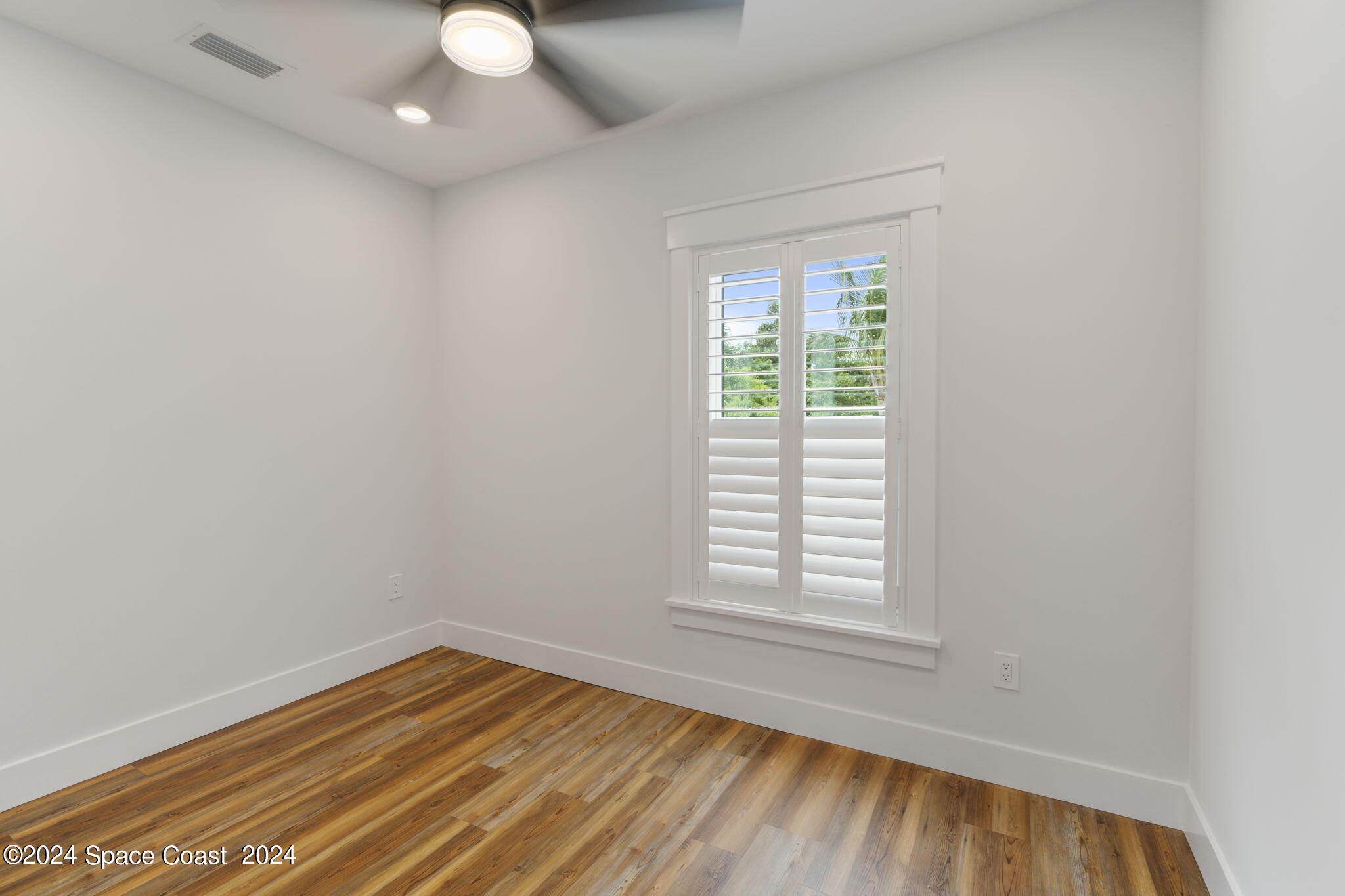 1760 Highway 1 Malabar, FL 32950 - Photo 30 of 40 an empty room with wooden floor and windows
