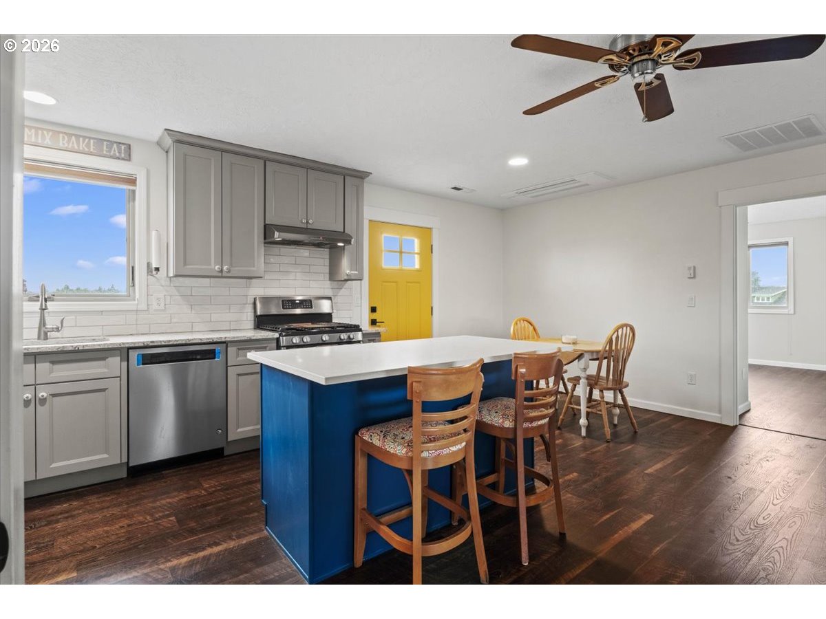 9864 Hoffman Road Monmouth, OR 97361 - Photo 33 of 48 a kitchen with a dining table chairs and white appliances