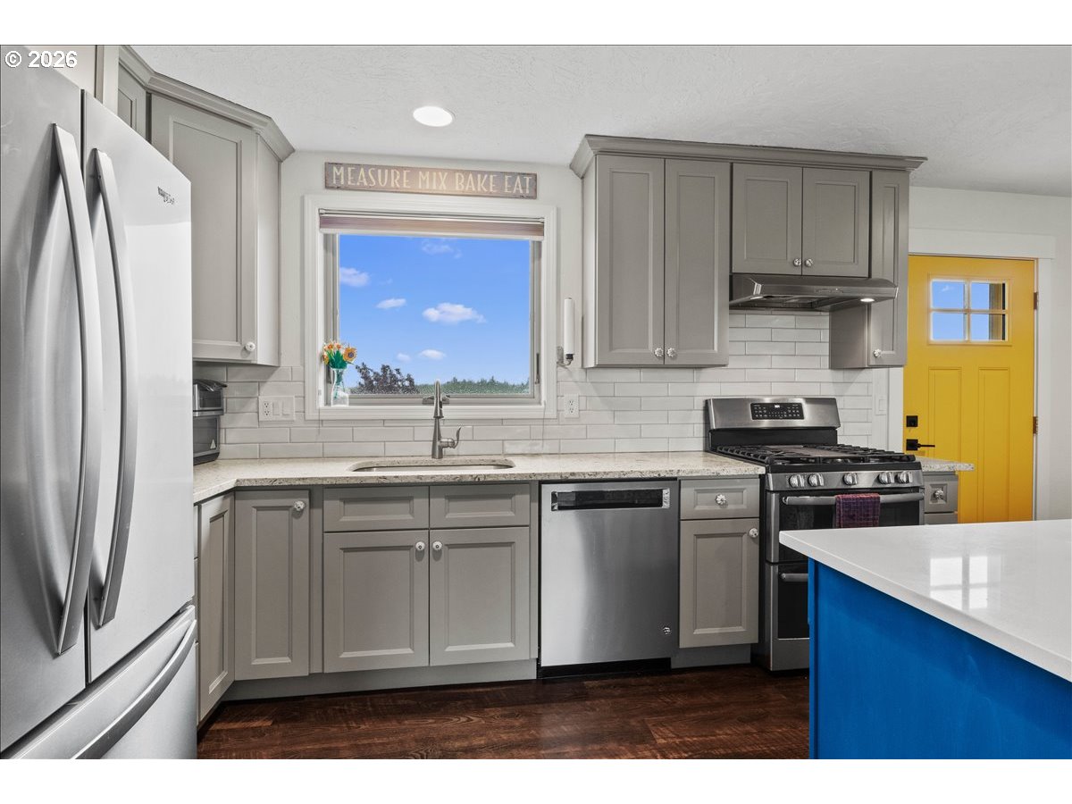 9864 Hoffman Road Monmouth, OR 97361 - Photo 36 of 48 a kitchen with stainless steel appliances granite countertop a stove a sink a refrigerator and a microwave
