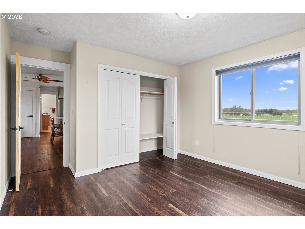9864 Hoffman Road Monmouth, OR 97361 - Photo 43 of 48 a view of an empty room with wooden floor and a window