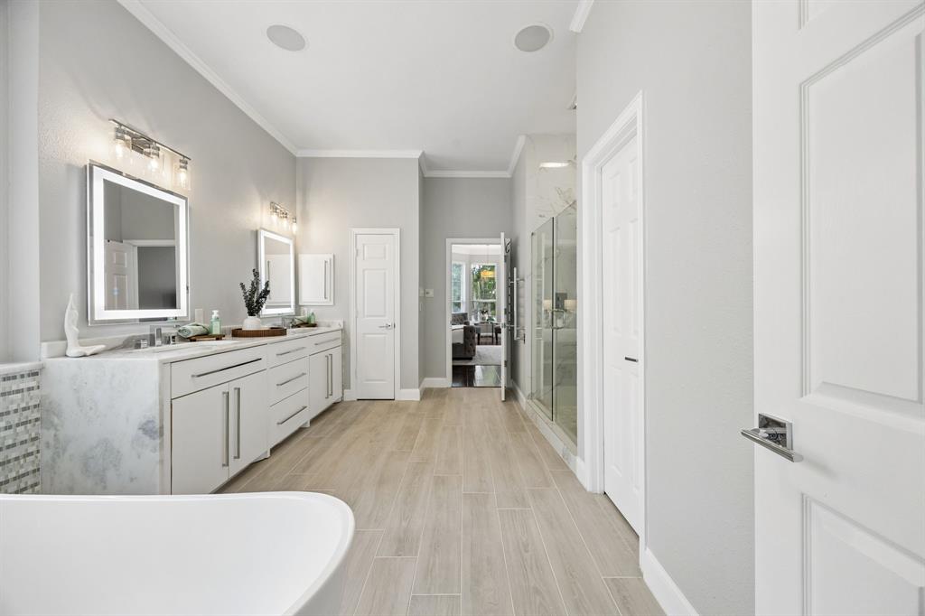 5808 Rathbone Drive Parker, TX 75002 - Photo 23 of 39 Another view of the primary bathroom shows the linen closet and medicine cabinet on the far wall. The separate watercloset and oversized walk in shower are to the right of the image.
