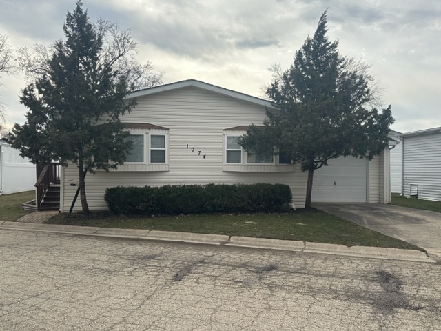 1074 Lakeview Road Elgin, IL 60123 - Photo 2 of 32 a house that has a tree in front of it