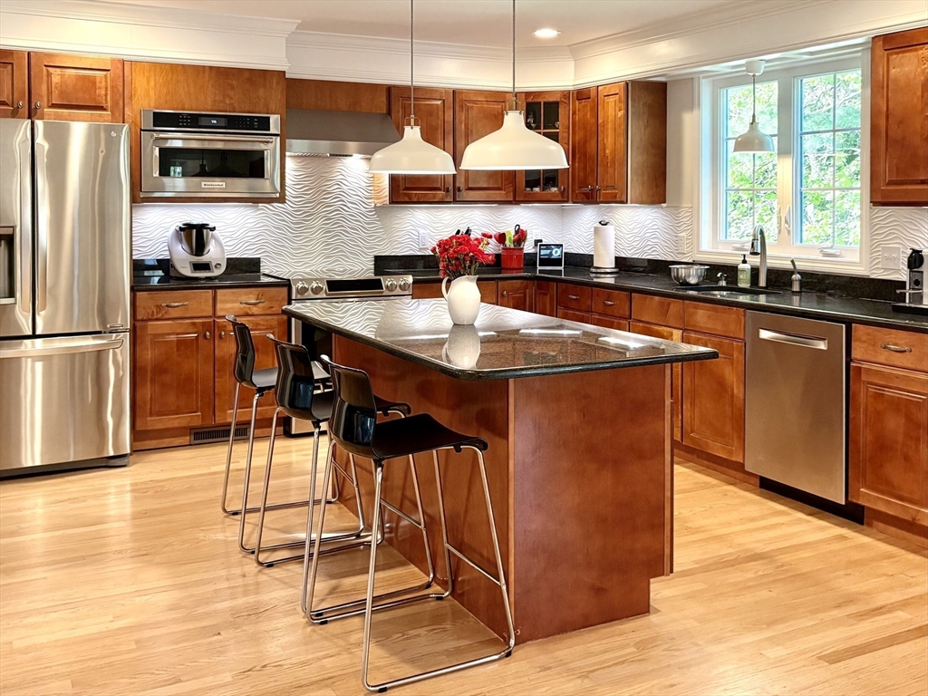 3 Wing Road Wilmington, MA 01887 - Photo 4 of 36 a kitchen with stainless steel appliances granite countertop a sink a stove and a refrigerator