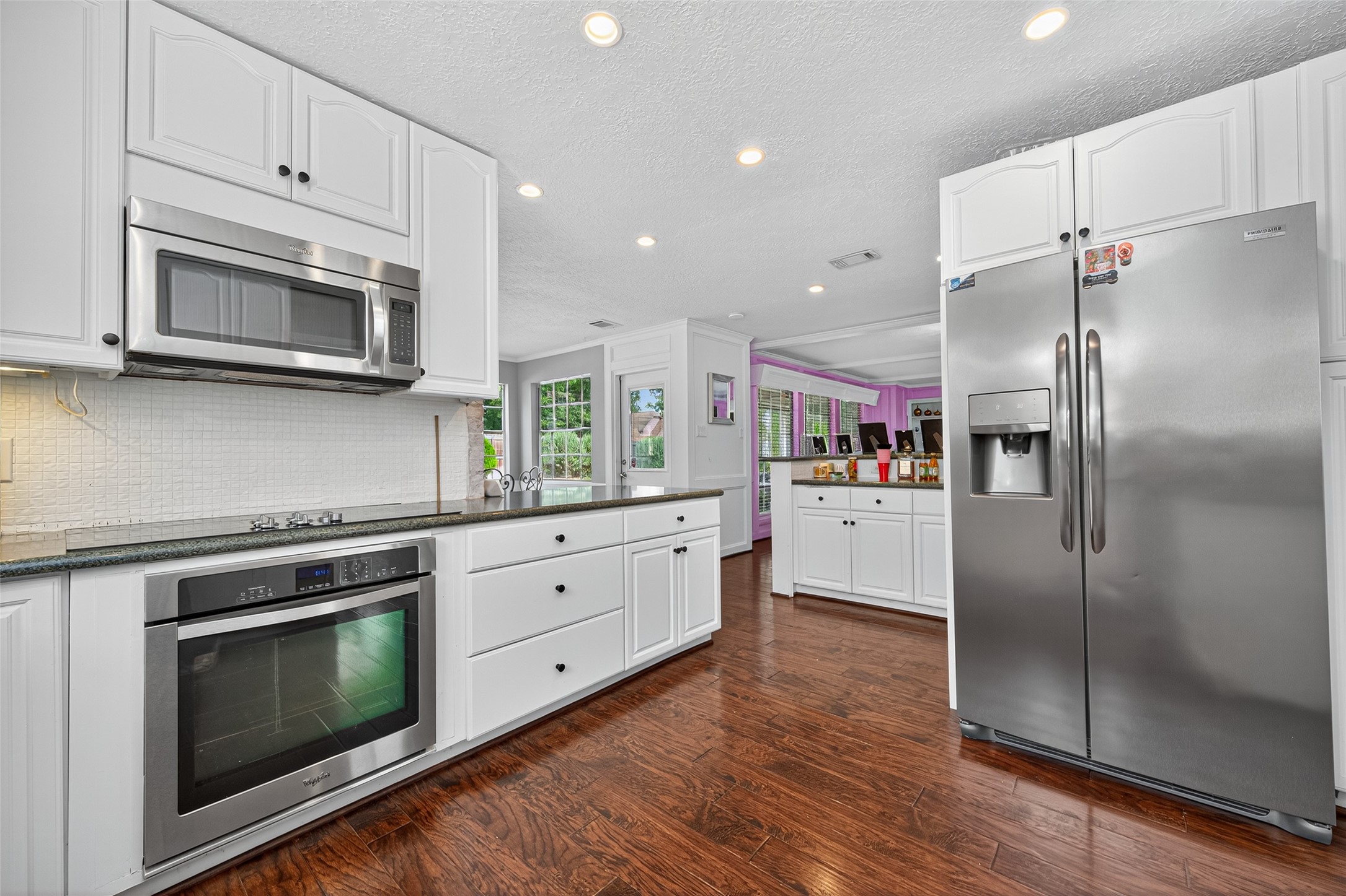 3602 Blue Cypress Drive Spring, TX 77388 - Photo 14 of 44 a kitchen with stainless steel appliances wooden floor sink and microwave