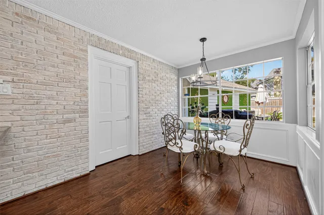 a dining room with furniture window and wooden floor