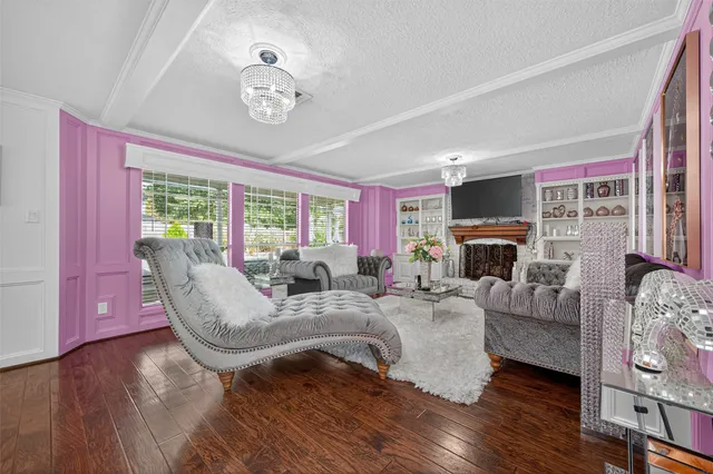 a living room with furniture a fireplace and a large window