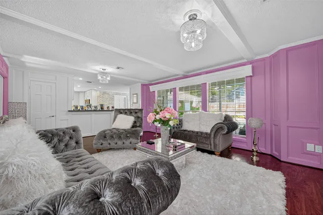 a bedroom with furniture and a large window