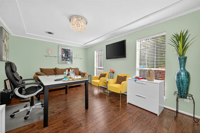 a living room with furniture window and a flat screen tv