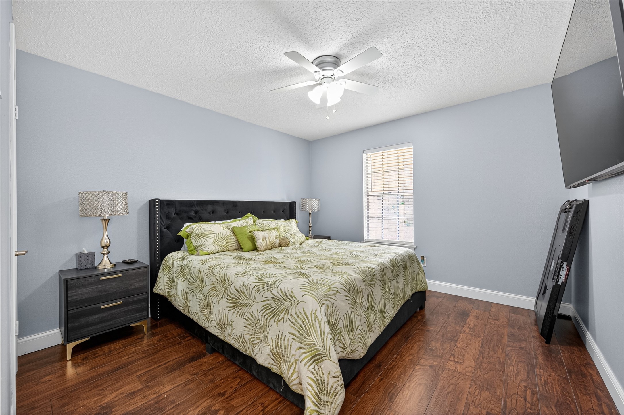 3602 Blue Cypress Drive Spring, TX 77388 - Photo 32 of 44 a bedroom with a bed and a flat tv screen on dresser