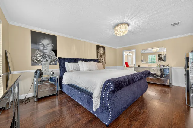 a bedroom with a bed and a chandelier