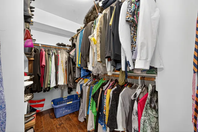 a view of walk in closet with clothes
