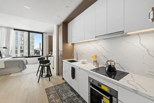 a bedroom with a large bed and a large window