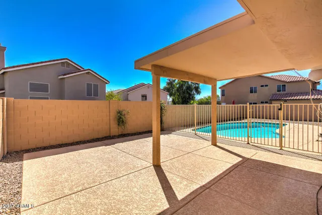 a view of a house with wooden fence