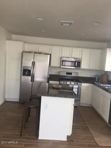 a kitchen with a refrigerator sink and stove