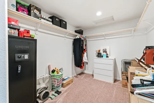 a utility room with fridge dryer and bicycles