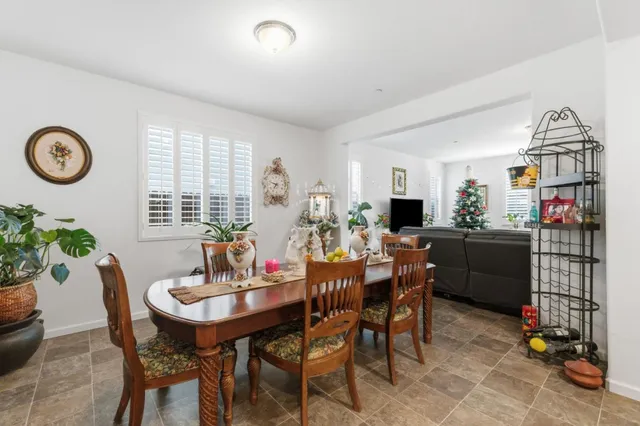 a view of a dining room with furniture and a chandelier