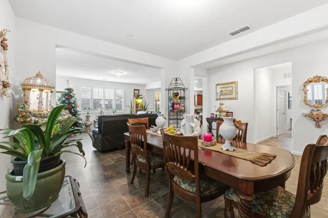 a view of a dining room with furniture and chandelier