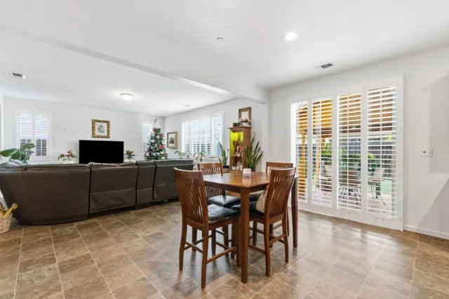 a view of a dining room with furniture window and outside view