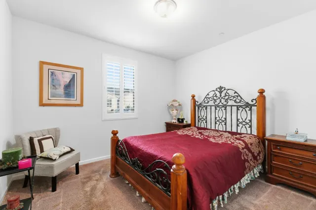 a bedroom with a bed and a dresser in it