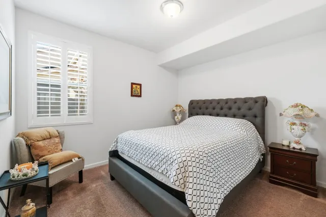 a bedroom with bed and window