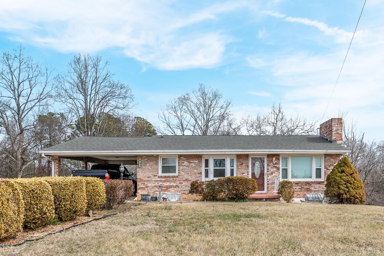 129 Greendale Drive Rustburg, VA 24588 - Photo 1 of 35 a front view of a house with a yard and seating space