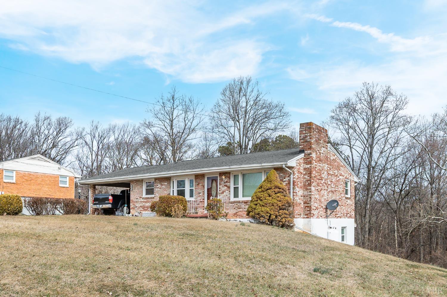 129 Greendale Drive Rustburg, VA 24588 - Photo 3 of 35 a front view of a house with a yard and garage